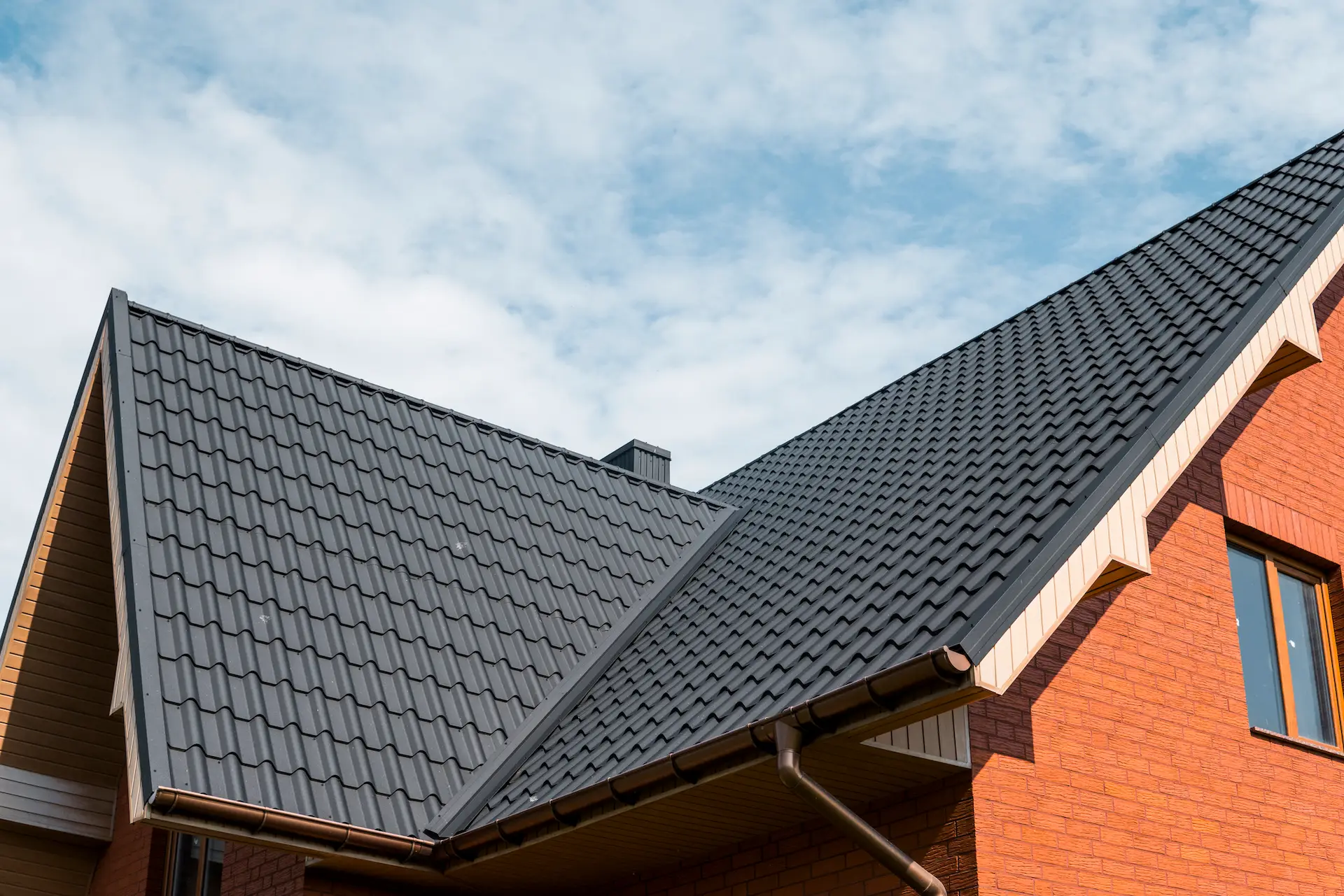 New metal roof installation on modern residential home exterior